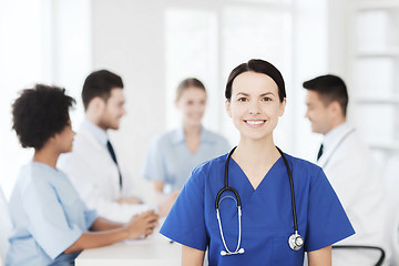 Image showing happy doctor over group of medics at hospital