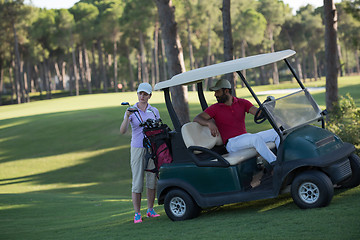 Image showing couple in buggy on golf course