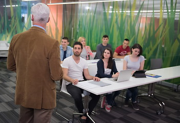 Image showing teacher with a group of students in classroom