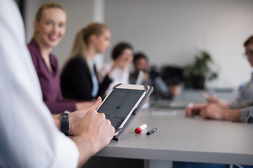 Image showing close up of  businessman hands  using tablet on meeting