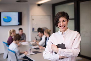 Image showing hispanic businesswoman with tablet at meeting room