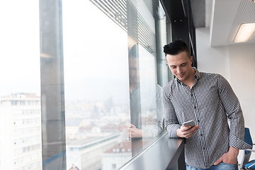 Image showing young business man using smart phone at office