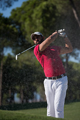 Image showing golfer hitting a sand bunker shot