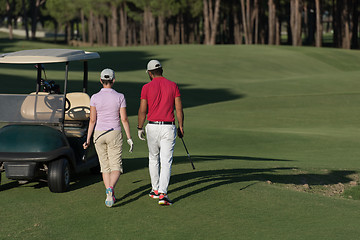 Image showing couple walking on golf course