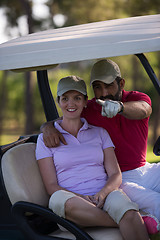 Image showing couple in buggy on golf course