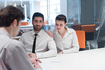 Image showing young couple signing contract documents on partners back