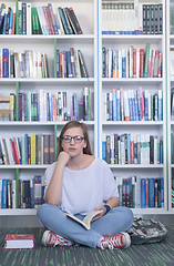 Image showing famale student reading book in library