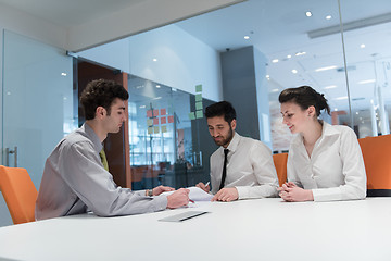 Image showing young couple signing contract documents on partners back