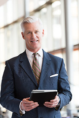 Image showing senior business man working on tablet computer