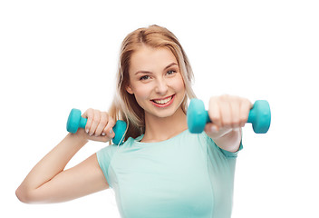 Image showing smiling beautiful young sporty woman with dumbbell