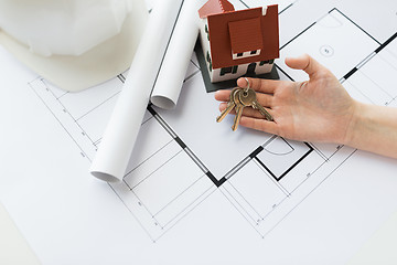 Image showing close up of hand with house keys and blueprint