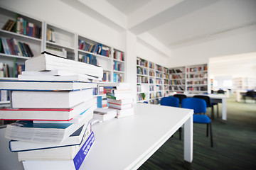 Image showing female student study in library, using tablet and searching for 