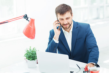 Image showing Portrait of businessman talking on phone in office