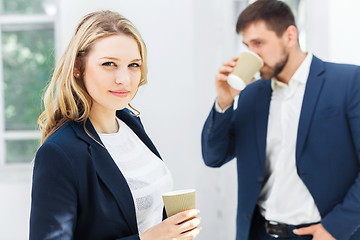 Image showing Young colleagues having coffee break in office