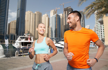 Image showing couple running over dubai city street background