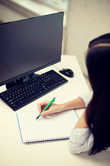 Image showing close up of sad woman with computer and notebook