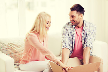 Image showing happy couple with open parcel box at home