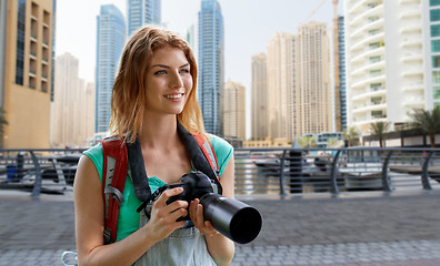 Image showing woman with backpack and camera over dubai city