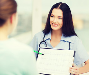 Image showing female doctor or nurse showing cardiogram