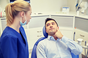 Image showing male dentist with woman patient at clinic