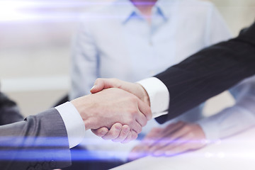 Image showing two businessmen shaking hands in office