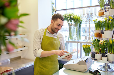 Image showing man with tablet pc computer at flower shop