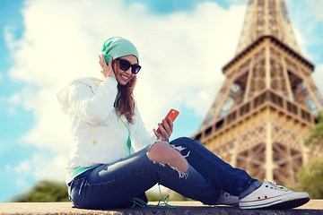 Image showing happy young woman with smartphone and headphones