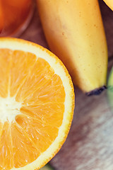 Image showing close up of fresh juicy orange and banana on table