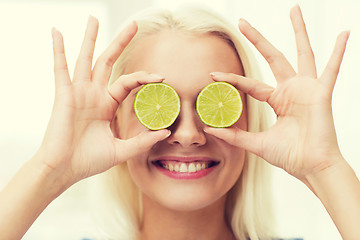 Image showing happy woman having fun covering eyes with lime