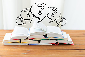 Image showing close up of books on table and question marks
