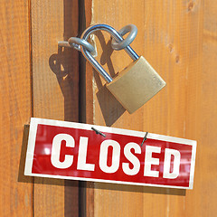 Image showing Padlock on a wood door with closed sign