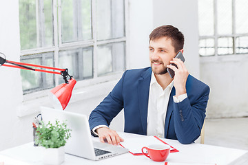 Image showing Portrait of businessman talking on phone in office