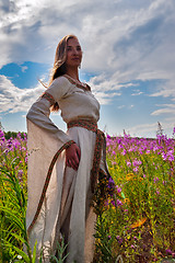 Image showing Beautiful girl relaxing among flowers