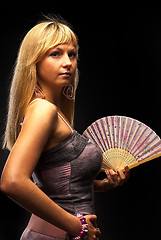 Image showing Beautiful young woman with fan