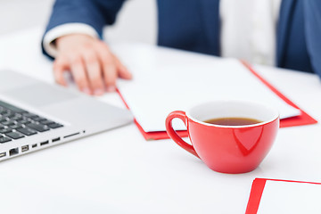 Image showing Businessman having coffee break, he is holding a cup 