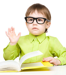 Image showing Little child play with book