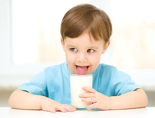 Image showing Cute little boy with a glass of milk