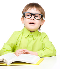 Image showing Little child play with book