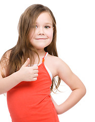 Image showing Little girl is showing thumb up gesture