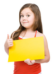 Image showing Little girl is holding blank yellow banner