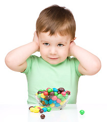 Image showing Portrait of a boy with candies