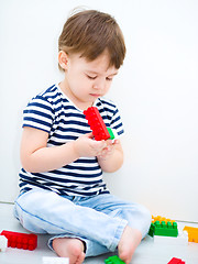 Image showing Boy is playing with building blocks