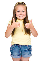 Image showing Little girl is showing thumb up gesture