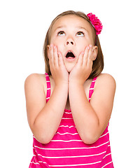 Image showing Little girl is holding her face in astonishment