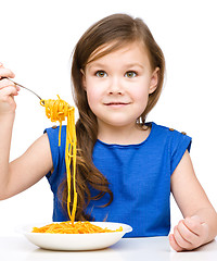 Image showing Little girl is eating spaghetti