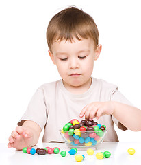 Image showing Portrait of a boy with candies