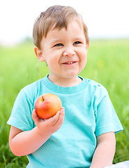 Image showing Portrait of a happy little boy with apple