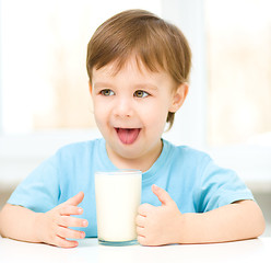 Image showing Cute little boy with a glass of milk