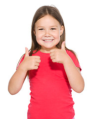 Image showing Little girl is showing thumb up gesture