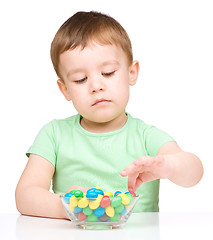 Image showing Portrait of a boy with candies